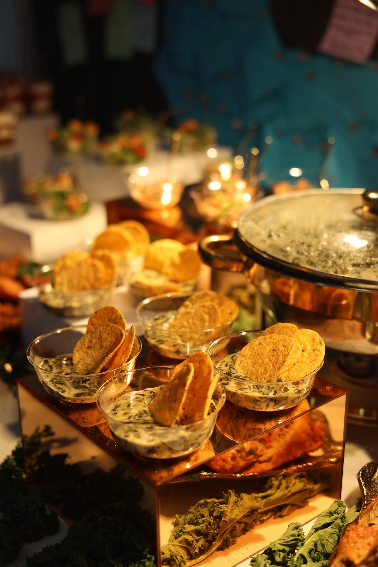 Catering display with chips and dip under warm lighting