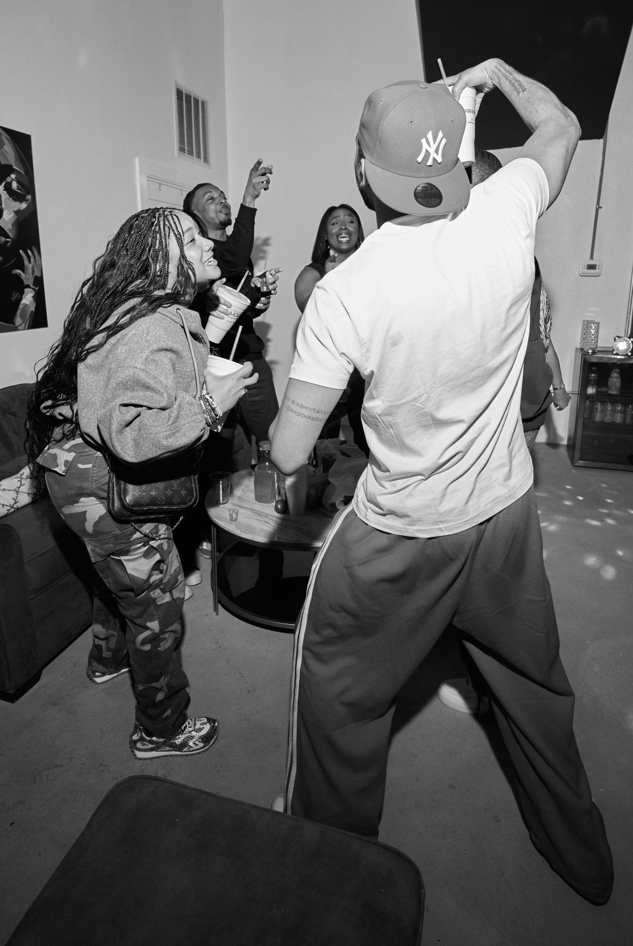 Black and white photo of guests dancing in the lounge